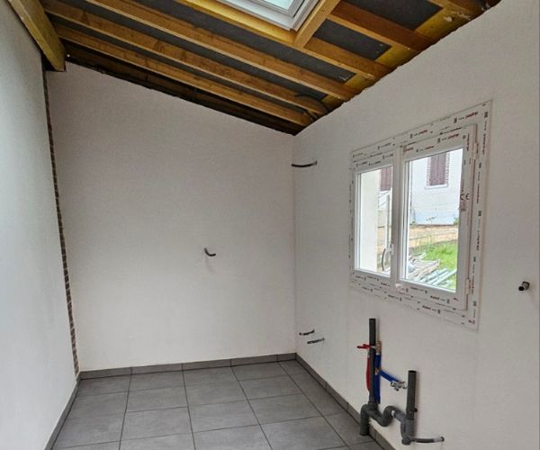 Finition intérieure d’une cuisine d’été avec isolation du plafond et pose de fenêtre.